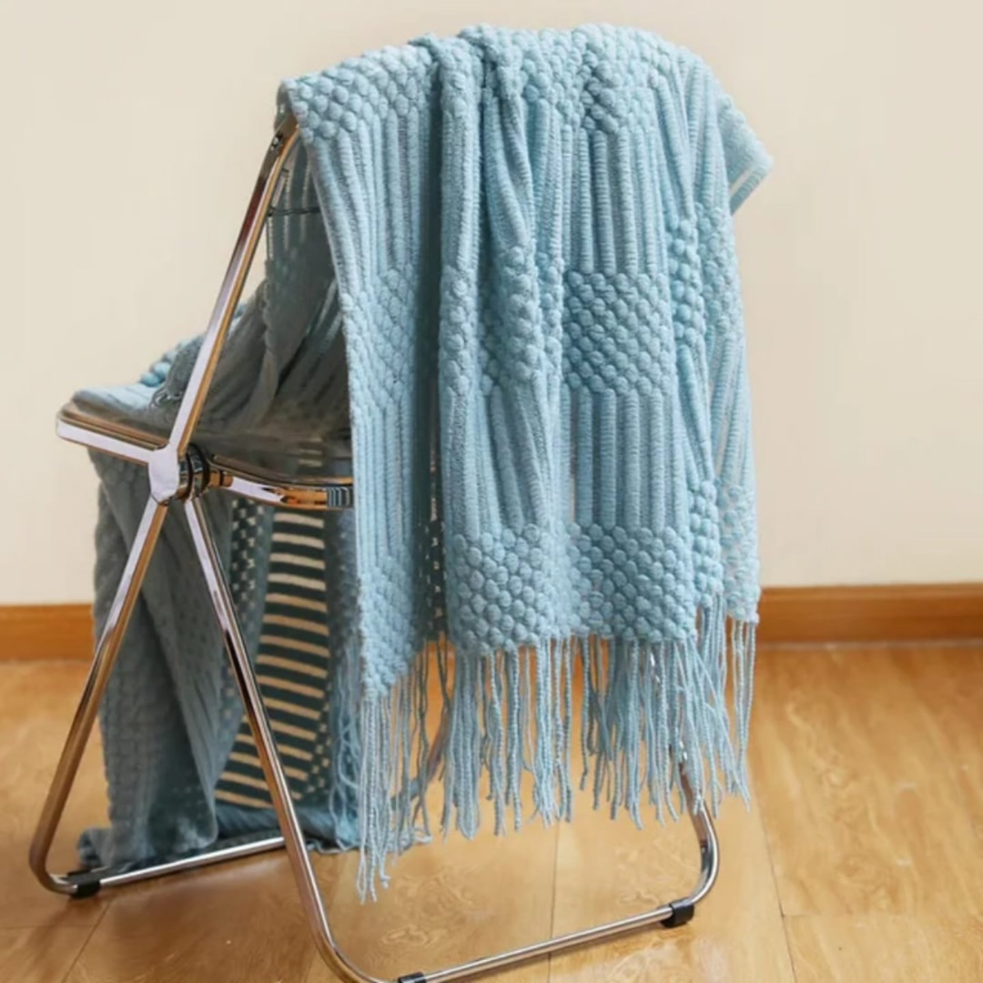 Knitted throw blanket with tassels